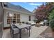 Inviting back patio with outdoor dining area, seating, a fire pit, and a grill, perfect for entertaining at 9118 Pine Springs Ct, Huntersville, NC 28078
