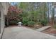 Beautiful backyard with a lush garden, a patio, a grill, and a bridge, creating a serene outdoor space at 9118 Pine Springs Ct, Huntersville, NC 28078