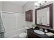 Bathroom with shower, a vanity with dark wood cabinetry, and a well-lit mirror at 9118 Pine Springs Ct, Huntersville, NC 28078