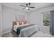 Cozy bedroom featuring a comfortable bed, ceiling fan, and a bright window for natural light at 9118 Pine Springs Ct, Huntersville, NC 28078
