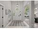 Bright foyer with a tiled floor, high ceilings, and an arched window above the white front door at 9118 Pine Springs Ct, Huntersville, NC 28078