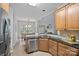 Well-appointed kitchen with granite counters, stainless steel appliances, wood cabinets, and open dining area at 9118 Pine Springs Ct, Huntersville, NC 28078