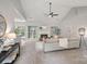 Bright living room featuring fireplace with white mantel, ceiling fan, and large windows for natural light at 9118 Pine Springs Ct, Huntersville, NC 28078