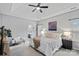 Bright main bedroom with a tray ceiling, neutral decor, large windows, and en suite bathroom at 9118 Pine Springs Ct, Huntersville, NC 28078