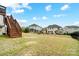 Spacious backyard, ideal for outdoor activities, features a tiered deck, and a dark metal fence at 10161 Castlebrooke Dr, Concord, NC 28027