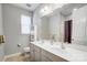 Well-lit bathroom with double sinks, a large mirror, and neutral tones at 10161 Castlebrooke Dr, Concord, NC 28027