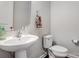 Powder room with pedestal sink and toilet at 10161 Castlebrooke Dr, Concord, NC 28027