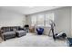 This bonus room has a couch, exercise equipment and nice natural light from the large windows at 10161 Castlebrooke Dr, Concord, NC 28027