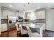 This modern kitchen has a large center island, stainless steel appliances and white cabinets at 10161 Castlebrooke Dr, Concord, NC 28027