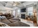 This open concept living room has lots of space, a fireplace, hardwood floors and nice lighting at 10161 Castlebrooke Dr, Concord, NC 28027