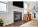 This living room features a fireplace, hardwood floors, and a nice entertainment center at 10161 Castlebrooke Dr, Concord, NC 28027