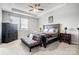 Relaxing main bedroom with a tray ceiling, a large bed, and ample space for a sitting area at 10161 Castlebrooke Dr, Concord, NC 28027