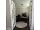 A home office featuring french doors, a neutral color scheme, and a large desk situated on a circular rug at 10161 Castlebrooke Dr, Concord, NC 28027
