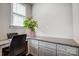A well lit home office with a large desk, granite countertops, plenty of storage space, and a houseplant at 10161 Castlebrooke Dr, Concord, NC 28027