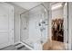 Modern bathroom features a glass shower with marble tile and a view into the walk-in closet at 10161 Castlebrooke Dr, Concord, NC 28027