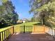 Wooden back deck overlooking a large, flat backyard and mature trees, with neighborhood views at 1090 Briarcliff Rd, Mooresville, NC 28115
