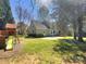 Landscaped backyard featuring a playset, mature trees, green grass, and a patio with access to the house at 1090 Briarcliff Rd, Mooresville, NC 28115