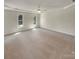 Spacious primary bedroom with neutral carpet and two windows offering plenty of natural light at 1090 Briarcliff Rd, Mooresville, NC 28115