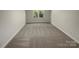 Bright bedroom featuring neutral carpet and a window, perfect for a guest room or home office at 1090 Briarcliff Rd, Mooresville, NC 28115
