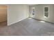 Bedroom featuring neutral walls, carpet flooring, bright natural lighting, and a spacious closet at 1090 Briarcliff Rd, Mooresville, NC 28115
