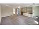 Primary bedroom with built in shelving, tray ceiling, and neutral carpet at 1090 Briarcliff Rd, Mooresville, NC 28115