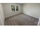 Comfortable bedroom with neutral carpet, a window, and closet space at 1090 Briarcliff Rd, Mooresville, NC 28115