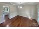 Elegant dining room boasts hardwood floors, wainscoting and crown molding, with a view of the kitchen at 1090 Briarcliff Rd, Mooresville, NC 28115