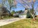 Two-story house with manicured lawn, paved driveway, mature trees, and an attached two-car garage at 1090 Briarcliff Rd, Mooresville, NC 28115