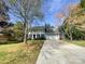 Charming two-story home featuring a manicured lawn, a long driveway, and an attached two-car garage at 1090 Briarcliff Rd, Mooresville, NC 28115