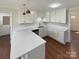 Kitchen featuring bright lighting, white cabinets, hardwood flooring, and modern stainless steel appliances at 1090 Briarcliff Rd, Mooresville, NC 28115