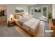 Bright main bedroom with neutral walls, carpet flooring, and modern decor and wall art at 1090 Briarcliff Rd, Mooresville, NC 28115