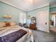 Serene bedroom with light blue walls and vintage furniture, offering a relaxing retreat at 11 Tallassee St, Badin, NC 28009