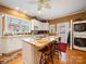 Bright kitchen with island, wooden floors, and stainless steel appliances at 11 Tallassee St, Badin, NC 28009