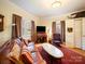 Inviting living room with a leather couch, and vintage decor at 11 Tallassee St, Badin, NC 28009