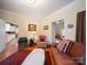 Warm living room with a comfortable leather couch, wood floors, and a cozy atmosphere at 11 Tallassee St, Badin, NC 28009