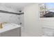 This bathroom features marble tile walls, gold hardware, and a modern vanity at 121 Tanglewood Dr, Kannapolis, NC 28081