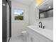 Bright bathroom featuring sleek vanity with matte black faucet and gray tile shower at 121 Tanglewood Dr, Kannapolis, NC 28081