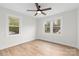 Light-filled bedroom with modern ceiling fan and plenty of natural light from two windows at 121 Tanglewood Dr, Kannapolis, NC 28081
