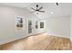 Spacious bedroom with a ceiling fan, light walls, and an exterior door to the backyard at 121 Tanglewood Dr, Kannapolis, NC 28081
