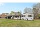 Charming brick home with fresh white paint, black trim, and well-manicured lawn at 121 Tanglewood Dr, Kannapolis, NC 28081
