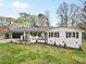 Charming ranch home with a black two-car garage, white facade and well-manicured lawn at 121 Tanglewood Dr, Kannapolis, NC 28081