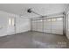 Clean garage interior with white brick walls and a bright overhead door at 121 Tanglewood Dr, Kannapolis, NC 28081