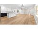 Open-concept floor plan showcases kitchen island and view to a light-filled living room at 121 Tanglewood Dr, Kannapolis, NC 28081