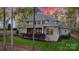 Charming backyard featuring a covered porch and beautiful landscaping at 138 Great Point Dr, Mooresville, NC 28117