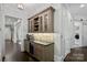 Charming bar area includes custom cabinetry, a wine fridge, and a beautiful tile backsplash at 138 Great Point Dr, Mooresville, NC 28117