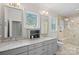 Bright bathroom with double sinks, granite countertops, tile flooring, and a glass enclosed shower at 138 Great Point Dr, Mooresville, NC 28117