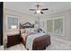 Sunlit bedroom featuring a large window, carpet, a comfortable bed, and stylish decor at 138 Great Point Dr, Mooresville, NC 28117