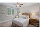 Cozy bedroom featuring carpet, a large window, a comfortable bed, and natural light at 138 Great Point Dr, Mooresville, NC 28117