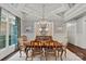 Elegant dining room boasts stylish chandelier, neutral color palette, and backyard view at 138 Great Point Dr, Mooresville, NC 28117