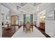 Dining room with coffered ceilings, statement chandelier, dark wood floors, and natural light at 138 Great Point Dr, Mooresville, NC 28117